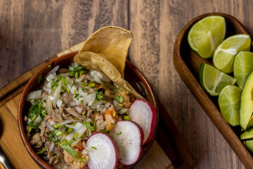 mexican food meat bowl, with meat juice cilantro and onion on the cover, mexican wooden plates