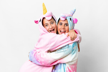 Friends girls with unicorn pajamas over isolated white background