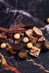 a variety of chocolates on a dark background