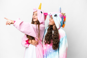 Friends girls with unicorn pajamas over isolated white background presenting an idea while looking smiling towards