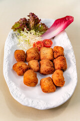 Nuggets in lettuce leaves on a white plate