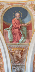 IVREA, ITALY - JULY 15, 2022: The fresco of St. Luke the Evangelist in cupola of church Chiesa di San Salvatore by Giovanni  Silvestro (1914).