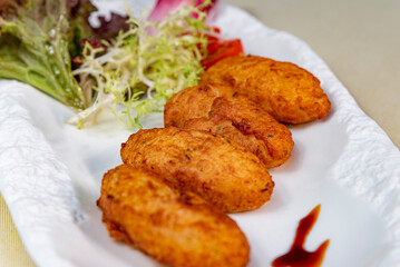 Crispy cod quenelles and fresh green salad