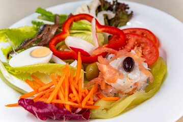 Green salad with cod, anchovies, egg and sweet pepper