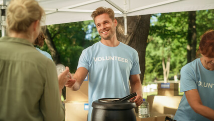 Positive Attractive Young Volunteer Working in Humanitarian Aid Center, Serving Free Food to People...