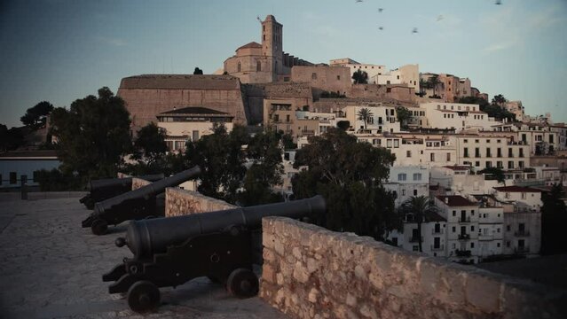 Old cannons and the old town of Ibiza, Dalt Vila, in the background