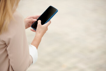 Hands of female entrepreneur answering messages on sartphone
