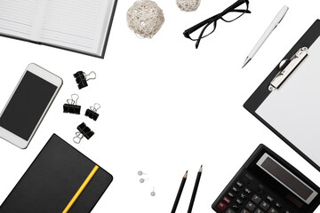 Office workspace with notebook, pen, coffee, clips and accessories.