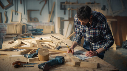 Young Woodworker Checking the Layout Manual of a Stylish Handmade Wooden Chair. Talented Furniture Designer Working in a Workshop in a Creative Loft Space with Tools and Equipment.