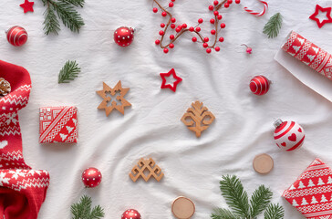 Blessed Yule, Christmas, Latvian winter festival. Ethnographic symbols and patterns from Latvia, wood amulets, wrapping paper, gift boxes with fir twigs and berries. Baltic seasonal patterns in red.