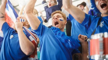 Sport Stadium Event: Crowd of Fans Cheer for their Blue Soccer Team to Win. People Celebrate Scoring a Goal, Championship Victory. Group of Friends with Painted Faces Cheer, Shout, Have Emotional Fun