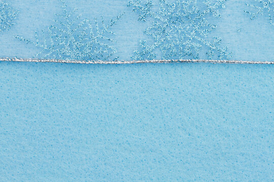 Snowflakes On Blue Felt Material Holiday Background