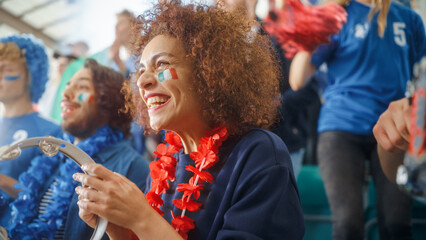 Sport Stadium Soccer Match: Portrait of Beautiful Bi Racial Fan Girl with Italian Flag Painted Face Cheering Team to Win, Beating Tambourine. Crowd Celebrate Goal, Championship Victory