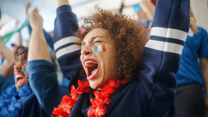 Sport Stadium Soccer Match: Portrait of Beautiful Bi Racial Fan Girl with Italian Flag Painted Face Cheering Team to Win, Beating Tambourine. Crowd Celebrate Goal, Championship Victory