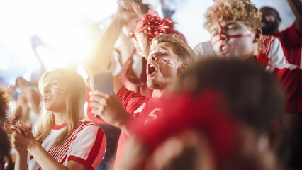 Sport Stadium Soccer Match: Caucasian Man Using Smartphone Cheering for Red Team to Win, Looking at Mobile Phone to Check App, Bet, Score, Winnings. Crowd Celebrate Goal, Championship Victory