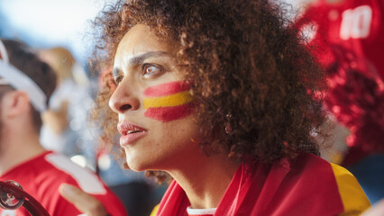 Sport Stadium Soccer Match: Portrait of Beautiful Bi Racial Fan Girl with Spanish Flag Painted Face Cheering Team to Win, Beating Tambourine. Crowd Celebrate Goal, Championship Victory - Powered by Adobe
