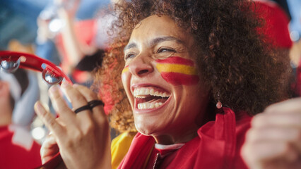 Obraz na płótnie Canvas Sport Stadium Soccer Match: Portrait of Beautiful Bi Racial Fan Girl with Spanish Flag Painted Face Cheering Team to Win, Beating Tambourine. Crowd Celebrate Goal, Championship Victory