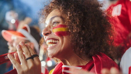 Sport Stadium Soccer Match: Portrait of Beautiful Bi Racial Fan Girl with Spanish Flag Painted Face...
