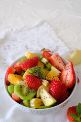 Bowl of healthy fresh fruit salad on a white napkin. Low calories, healthy snack