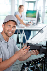 male technician fixing a printer