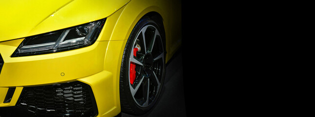 Yellow modern car headlights on black background, copy space 