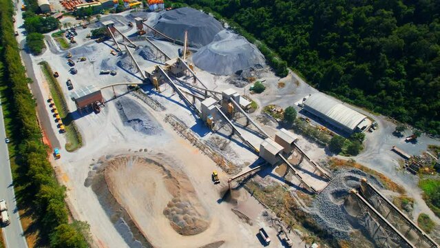 Drones are flying over stone crushing plant. commercial stone industry. Construction and respiratory pollution concept. environmental issues. Southeast asia. Aerial view footage. 4K
