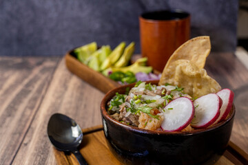 tostadas carne typical mexican food, wooden plate and wooden bottom, radish and onion