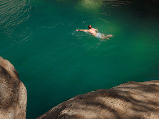 Obraz premium Turkey travel, mediterranean area on a warm summer day. Young woman in swimsuit have fun in mountain river. Concept of living open air, Travel , active lifestyle, summer vacation.