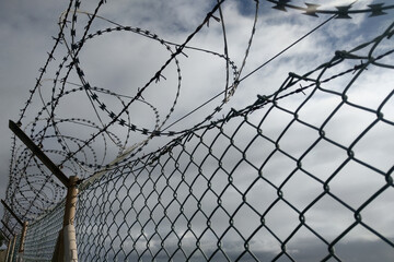 View of the barbed wire fence at the border of countries.