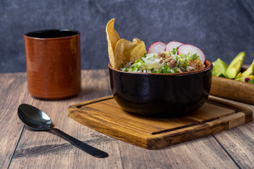 mexican food meat bowl, with meat juice cilantro and onion on the cover, mexican wooden plates