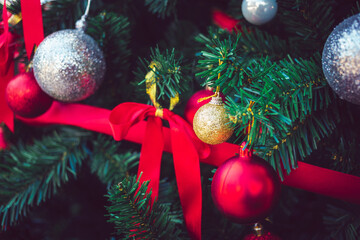Gold Christmas balls and red balls with red ribbons adorn on Christmas tree.  Christmas background. New Year concept.