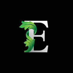 Initial letter E, 3D luxury green leaf overlapping white serif font on black background