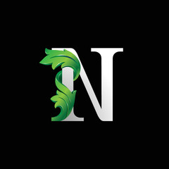 Initial letter N, 3D luxury green leaf overlapping white serif font on black background