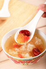 Female Hand Hold Spoon, Eat Peach Gum Collagen Dessert