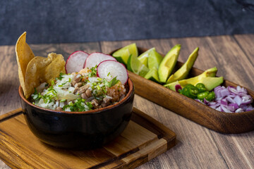 meat in its juice with golden tortilla, toasted, prepared with radishes and spicy sauces