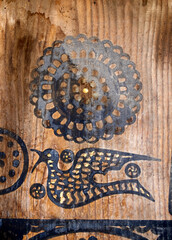 bird and geometric motifs on the old wooden door.