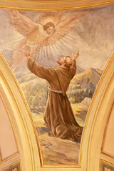 Tuinposter VARALLO, ITALY - JULY 17, 2022: The fresco of Stigmatization of St. Francis of Assisi in the church  Chiesa di sant Antonio by C. Secchi from 20. cent. © Renáta Sedmáková