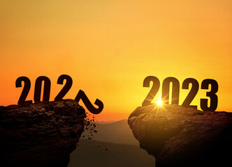 New Year's Eve 2023 on the mountain at sunset, concept. 2022 and 2023 on the cliff at sunrise,...