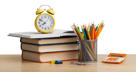 Stacked books with colorful pencils on the desk