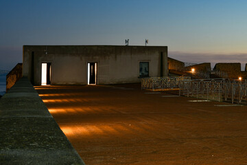 The panoramic terrace of the castle of Baia in a photo at dusk, Italy.