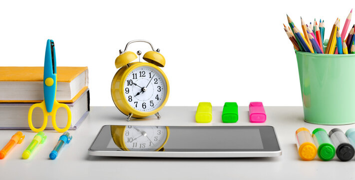 Colorful school supplies and digital table on wooden desk - Powered by Adobe