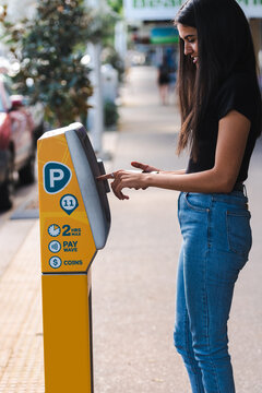 indigenous woman using car parking machine