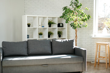 Grey sofa in simple living room interior