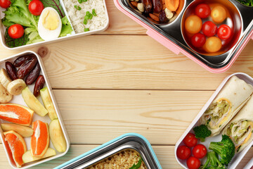 Containers with healthy food on wooden background top view.