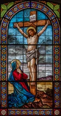 Foto op Canvas DOMODOSSOLA, ITALY - JULY 19, 2022: The Crucifixion and mother Mary on the stained glass in church Chiesa dei Santi Gervasio e Protasio by Luigi Fontana from 19. cent. © Renáta Sedmáková