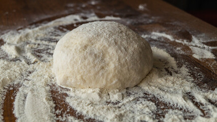 Fototapeta na wymiar Baking dough on the table. Dough and flour. Baking bread