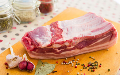 cooking traditional homemade lard with spices. pork belly with layer on board