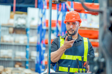 engineer in helmets order and checking goods and supplies on shelves with goods background in warehouse.logistic and business export ,Warehouse worker checking packages on shelf in a large store