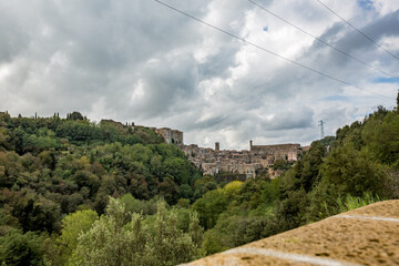 Far away view, town of Sorano, Tuscany, Italy. Moody late autumn travel perspective.