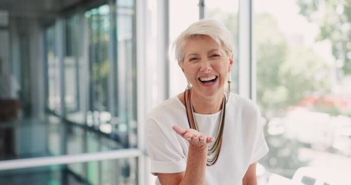 Senior woman, blow kiss and office with smile, silly and happiness on face at insurance business. Happy corporate executive, old woman and blowing kisses for comic portrait at workplace in Toronto